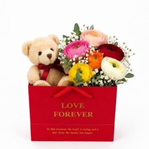 Teddy bear with colorful ranunculus flowers in a red gift box by Raindrops Flower Vancouver